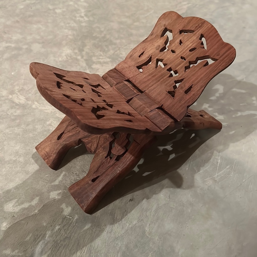 Small wood carved collapsible book holder